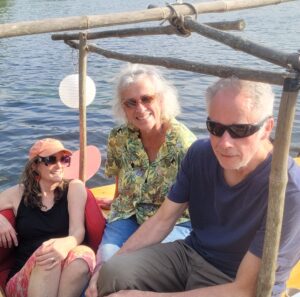 Three people smiling on a boat